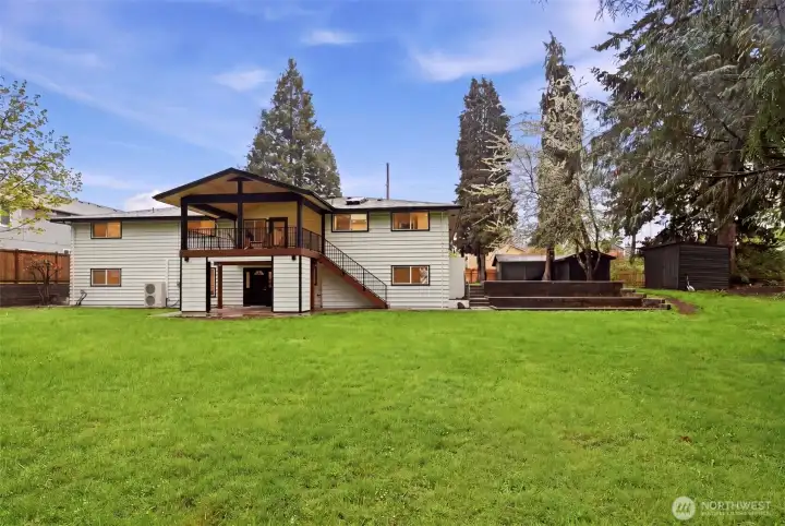 Yard feels massive for a 0.6 acre lot! See huge sheds in back of photo