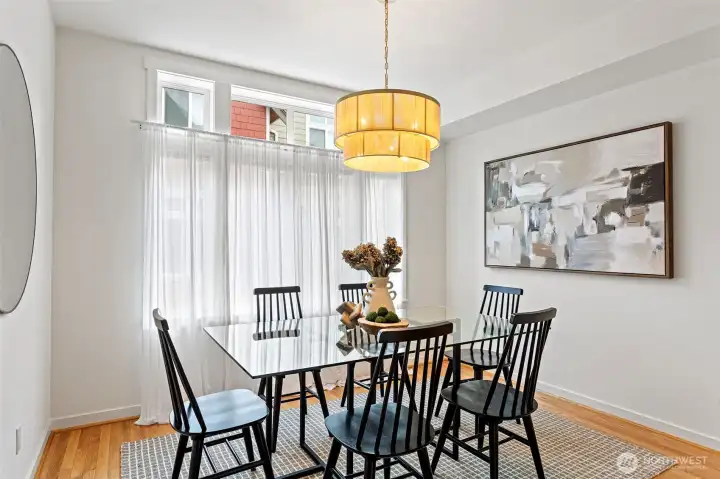 The dining room features a wall of windows with transom windows above letting in so much beautiful light.  A new statement chandelier was just added.