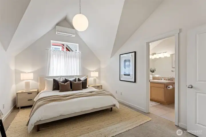 The Primary Suite on the upper level features vaulted ceilings and an en-suite bath.  A ductless mini split system throughout the home keeps you cozy in the winter and cool in the summer.