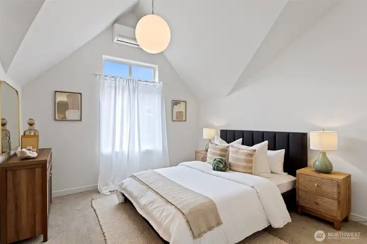A second upstairs primary bedroom features vaulted ceilings and a newly added dramatic globe light fixture.  This bedroom also feature heating and A/C.