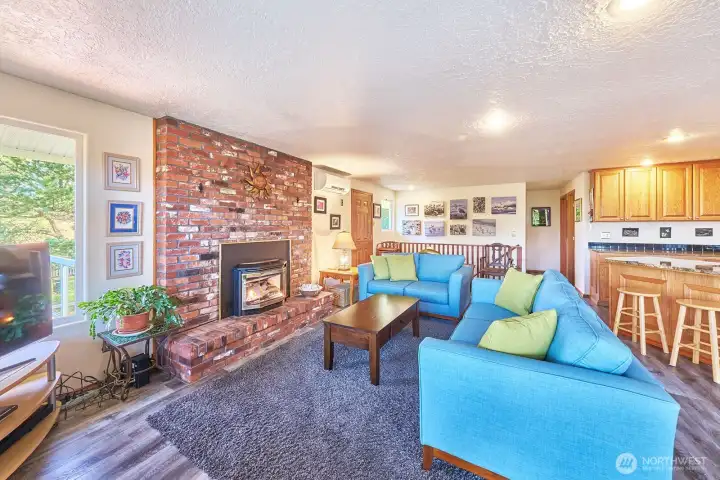 Enter into a lovely open plan great room with attractive brick fireplace surround