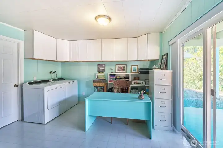 Laundry and office or craft area with slider to covered patio