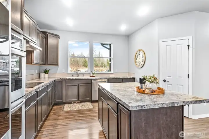 The spacious kitchen has ample storage, soft close cabinets and drawers and a walk-in pantry.