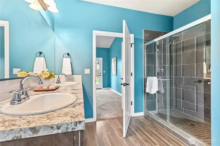 Gorgeous primary bathroom with a large walk in closet, tub, double vanity, separate toilet room and access to the large walk-in closet.