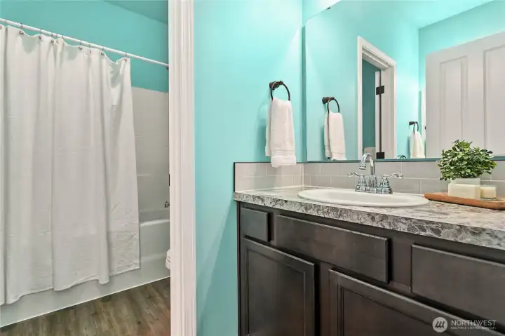 The full bathroom has double vanities and a separate shower and toilet room.