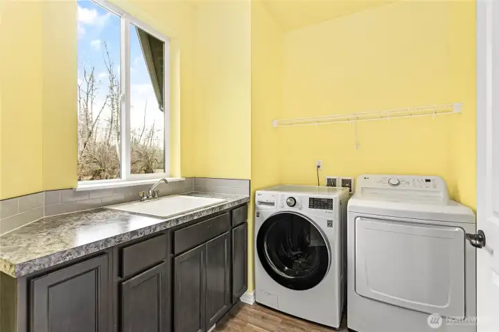 Large laundry room located next to the garage door for easy access. Washer and dryer are included!