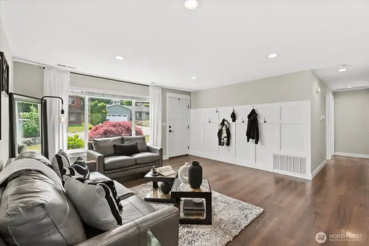 Updated flooring and custom shiplap wall make this space inviting for friends and family.