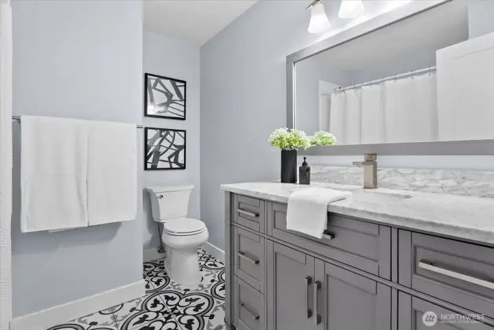 Full guest bath completely upgraded across the hall from Bedroom 1 & 2.