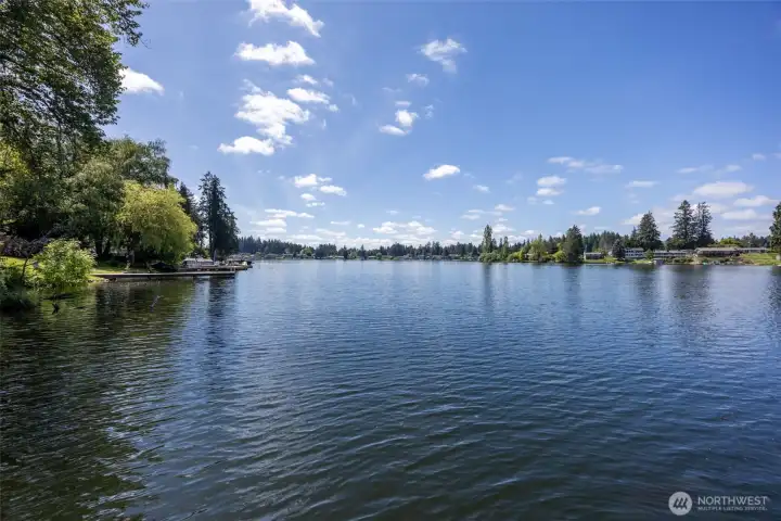 Long Lake has earned a serious reputation locally as one of the best swimming lakes in Thurston County, and once you see the water in person it becomes pretty obvious why people love it so much. Open year-round, the lake stretches roughly 2 miles long and is formed by two larger basins connected through a narrow channel, giving it a really beautiful varied shape, and much more fun to kayak in! Water feeding in from nearby Pattison Lake eventually flows through Woodland Creek and Lois Lake toward Henderson Inlet, helping support the healthy lake ecosystem and recreation people enjoy here year after year. And yes, the neighborhood lake culture is alive and well too! Every New Year’s Day, the nearby Long Lake Park area on the other side of Holmes Island hosts an annual Polar Bear Plunge, so if you hear cheering laughter and suspicious levels of screaming across the water on January 1st, congratulations, you officially live on a fun lake!