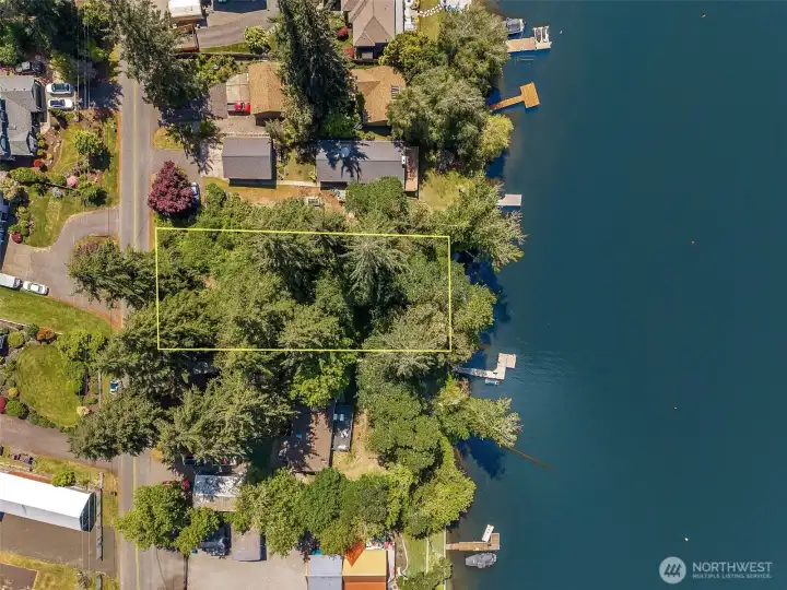 Standing at the waterfront, you immediately understand why people fight so hard to get onto Long Lake and never want to leave! The mature trees lining the shoreline create this gorgeous layered natural backdrop, so you cannot quite capture the entire 110 feet of frontage from ground level in one shot, but honestly that only adds to the secluded tucked-away feeling of the property. The waterfront actually usable and swimmable right from day one, kayaks, paddleboards, fishing, waterskiing, jet skis, swimming, sunset boat rides, all of it starts right here from your own future backyard. Raw waterfront land with this kind of recreational potential is becoming incredibly hard to find, especially on a lake large enough to genuinely enjoy motorized boating activities without feeling cramped.