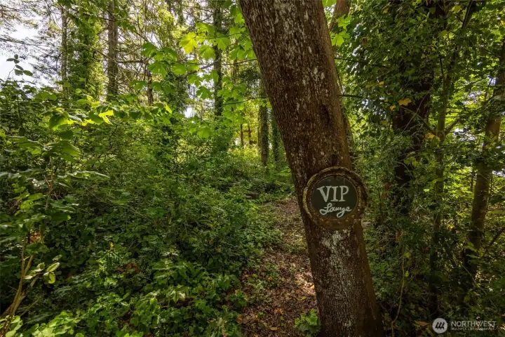 Just beyond the gated driveway entrance, the world starts feeling quieter fast. This over-half-acre waterfront parcel unfolds into its own little forested retreat with towering trees, lush undergrowth and a gentle slope leading naturally down toward the lake instead of some terrifying cliffside situation requiring hiking boots and emotional preparation. The setting feels wonderfully tucked away and private while still sitting inside the Lacey Urban Growth Area, which is a huge advantage for future development potential because you are positioned near established infrastructure, nearby sewer access, public water on the lot side of the road and all the conveniences that come with being close to an urban service area. Translation: you get the “middle of nowhere” feeling without ACTUALLY being in the middle of nowhere. No feasibility studies have been completed yet, leaving the next owner the opportunity to explore and shape the vision for this rare waterfront property themselves.