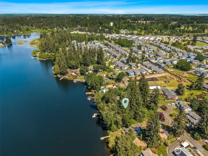 From this southwest aerial perspective, you really start appreciating the layered beauty of this entire lake system. Holmes Island anchors the center view while nearby Hicks Lake stretches into the distance beyond, highlighting how interconnected and water-rich this whole area feels. This property sits within the northern basin of Long Lake, the section nearest Hicks Lake, while the southern basin extends out beyond the right side of this image. The setting feels peaceful, scenic and wonderfully tucked away from heavier activity areas while still giving full access to all the lake recreation people love here. The property also falls within the North Thurston Public Schools district including Seven Oaks Elementary School, Nisqually Middle School and River Ridge High School. Students may additionally pursue enrollment through Aspire Middle School, a lottery-based public middle school program with an arts-centered curriculum emphasizing visual and performing arts opportunities.