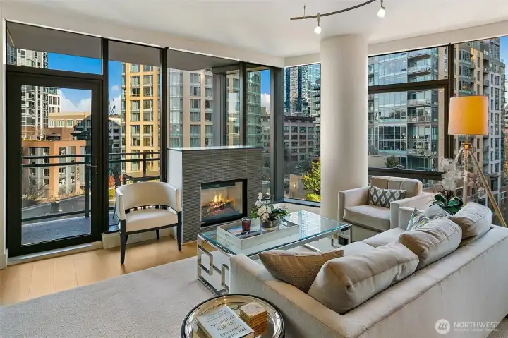 Cozy gas fireplace anchors the living room, but does not distract from the floor to ceiling window wall views.