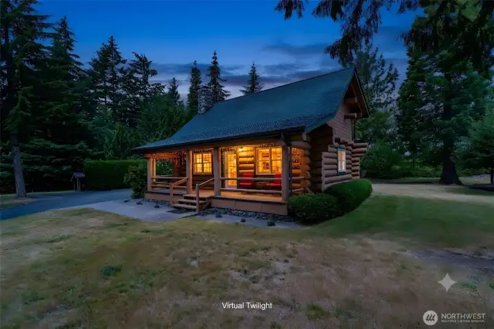 Stunning custom-built log cabin with beautiful landscaping.