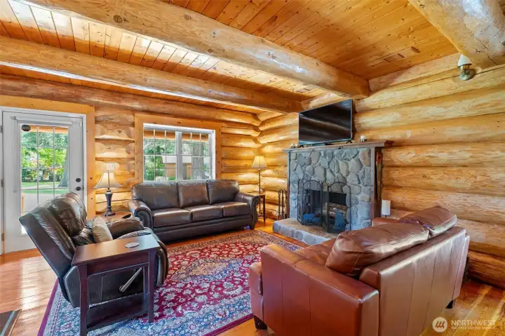 River rock fireplace stands out perfectly against the finished wood.