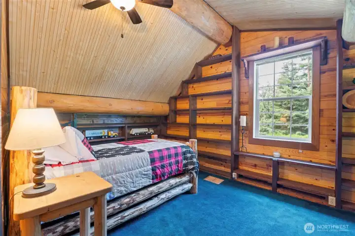 Loft area with built-in shelves.