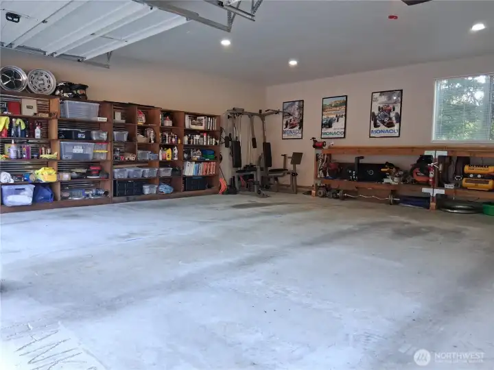 Interior of garage. Lots of shelving and workspace.
