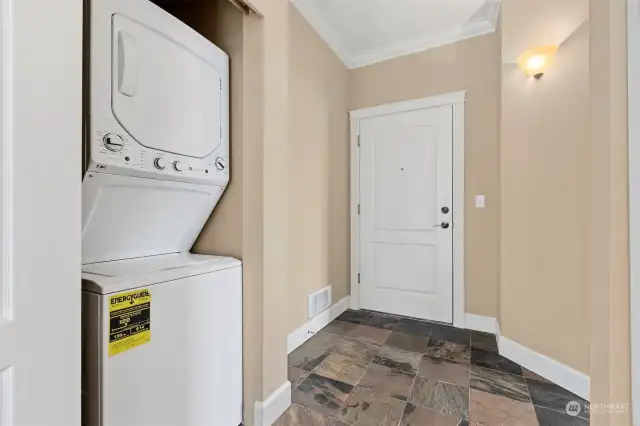 The washer and dryer are in a closet between the entry and primary suite.