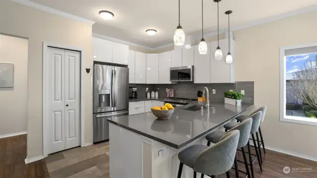 Full remodel with quartz counters, white cabinets and stainless steel appliances