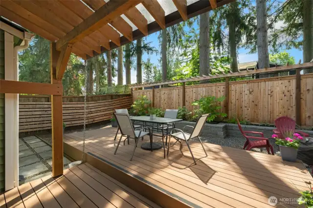 A little slice of heaven in the backyard with raised deck and covered area at slider.