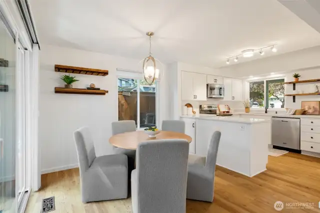 Dining area with slider and window to side yard.