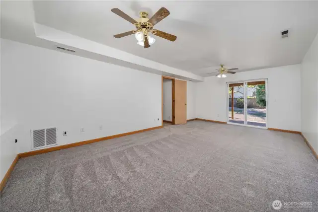 The spacious downstairs family room opens right out to a large backyard—perfect for relaxing or entertaining.