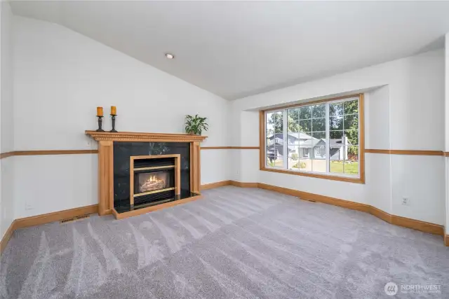Bright and spacious living area featuring a cozy gas fireplace!