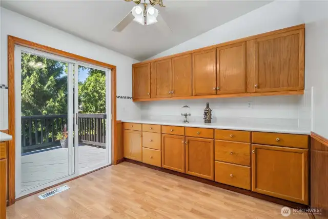 Eat-in kitchen with a buffet area that opens onto a spacious deck—perfect for indoor-outdoor entertaining.