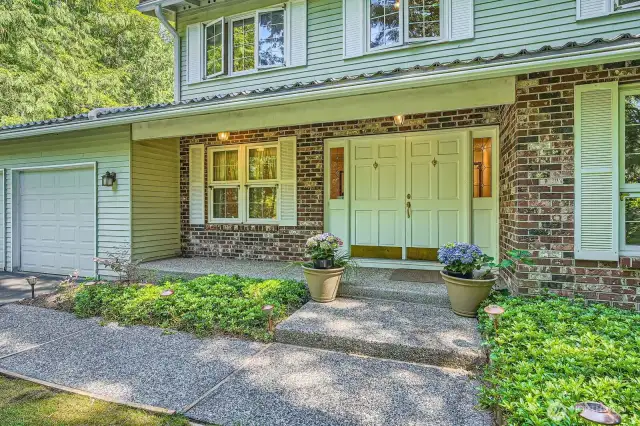 Welcoming covered porch to double door entrance