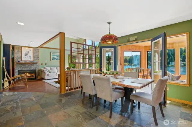 Dining room with French doors that lead to the covered sun room. Big windows allow ample sunlight into the home.