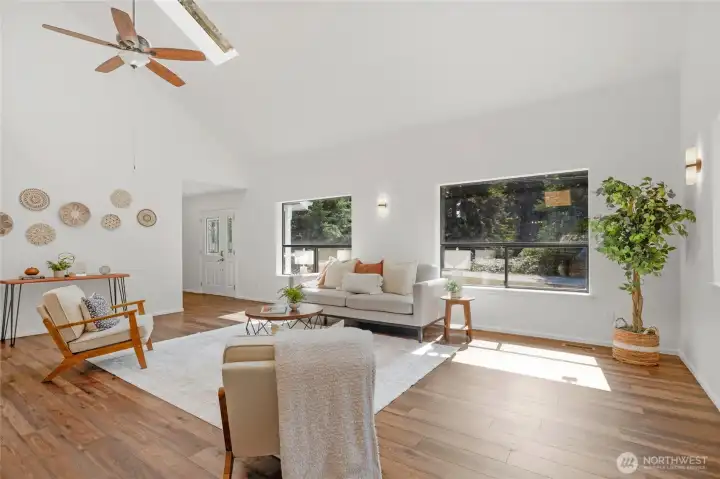 Large living area with vaulted ceilings with skylights.