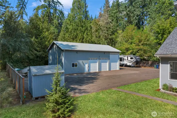 Shop sits to the back of the acre + a garden shed!