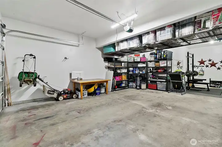Tandem 3 car garage with over head storage.  2 EV charging stations.