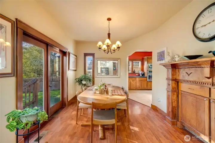 Comfort, light, and space – a dining room perfect for everyday living. Built in storage and a custom wood surround on the right.