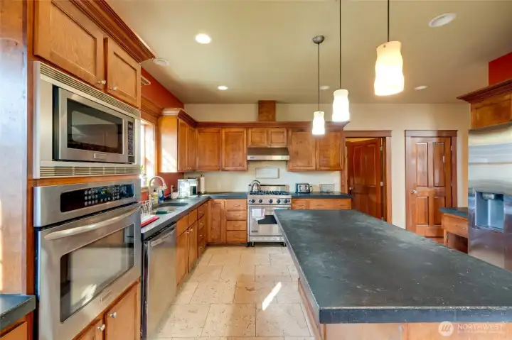 To the right of the stove is the laundry room and to the right of the laundry room, the kitchen pantry.