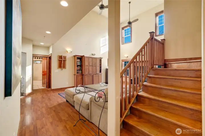 Looking from the kitchen pantry door towards the stairwell, living room and downstairs full bath.