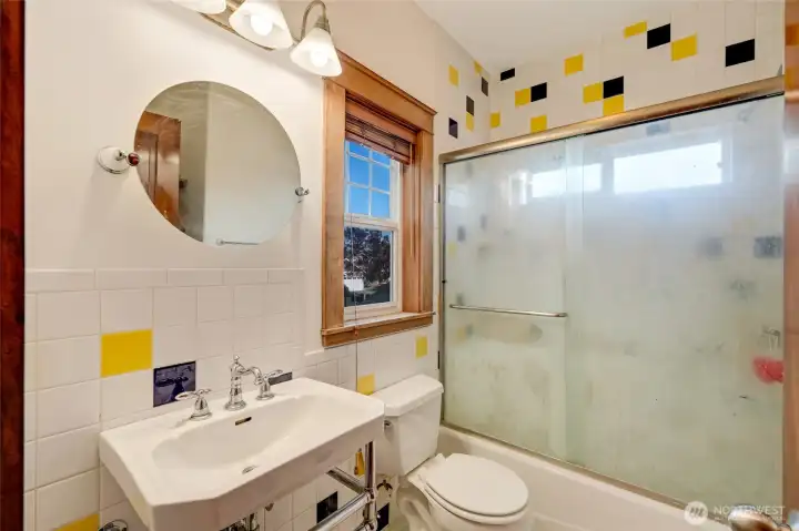Upstairs Bathroom #2 with ceramic tile tub enclosure and wainscot wall.