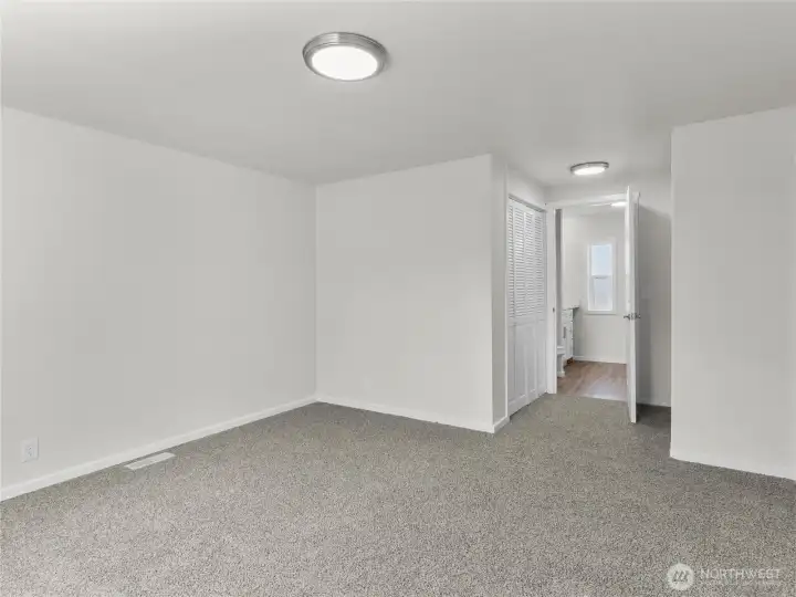 Primary bedroom has dual closets leading to the ensuite bath