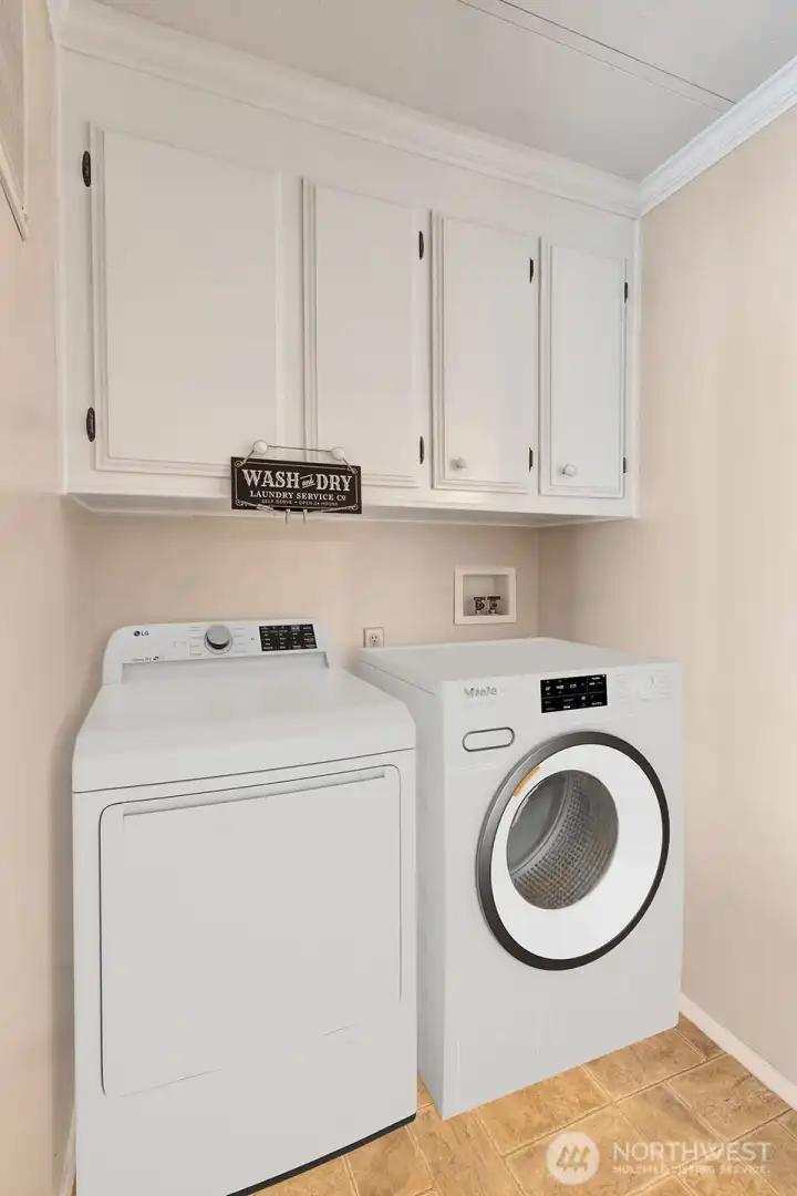 Utility room has cabinet storage above washer, dryer area for all your laundry necessities. Access door to the private, fenced back yard.