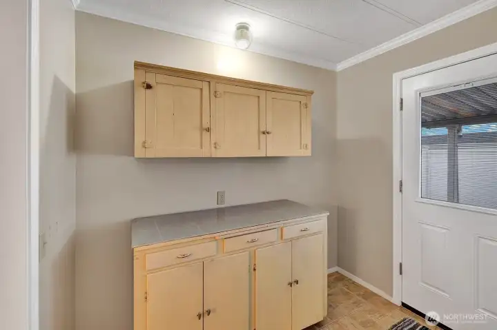 Vintage cabinet in laundry room with additional storage space. Super convenient space to fold laundry etc. Access door to back yard has custom built in blinds for privacy.