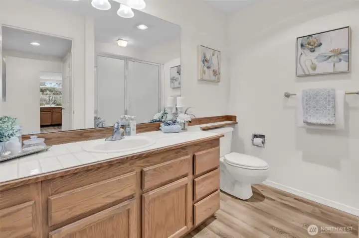 LVP flooring continues into bathroom. New light fixture.