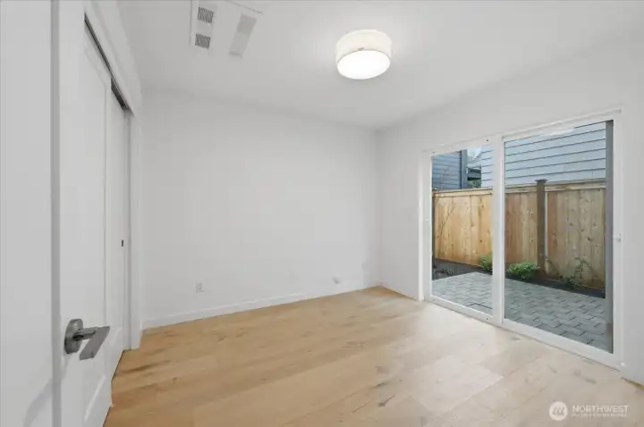 Main Floor Bedroom with Hardwoods and a Slider to the Patio
