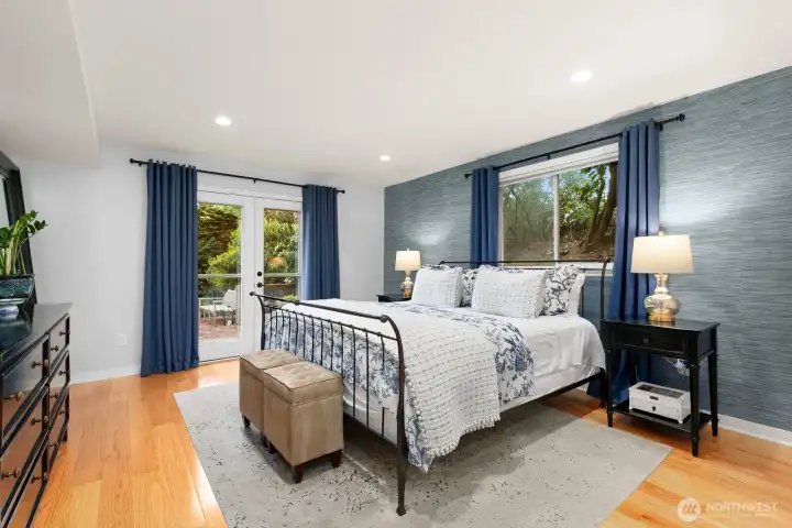 The lower level features a serene primary bedroom retreat with full bath, stunning views, and direct access to a patio and backyard.