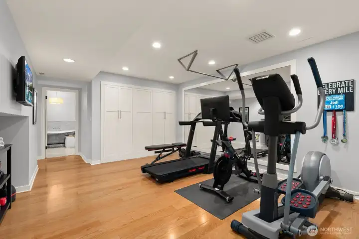 A fifth bedroom, gym or flex space, and access to the one-car garage with EV charging complete this level.