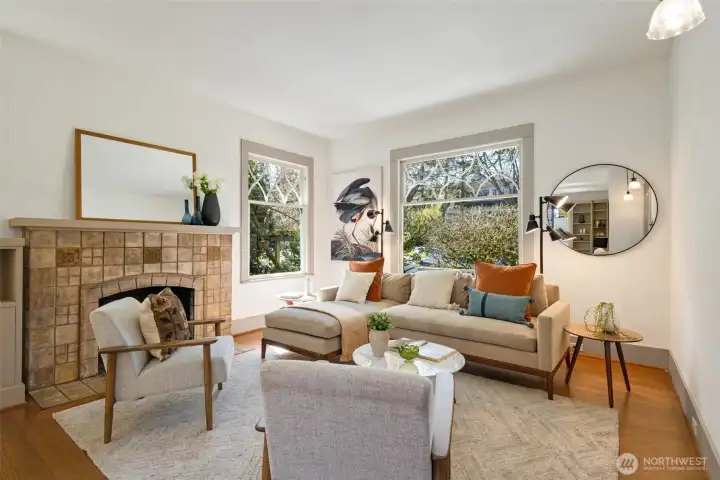 Living room features a Batchelder wood-burning fireplace and period windows