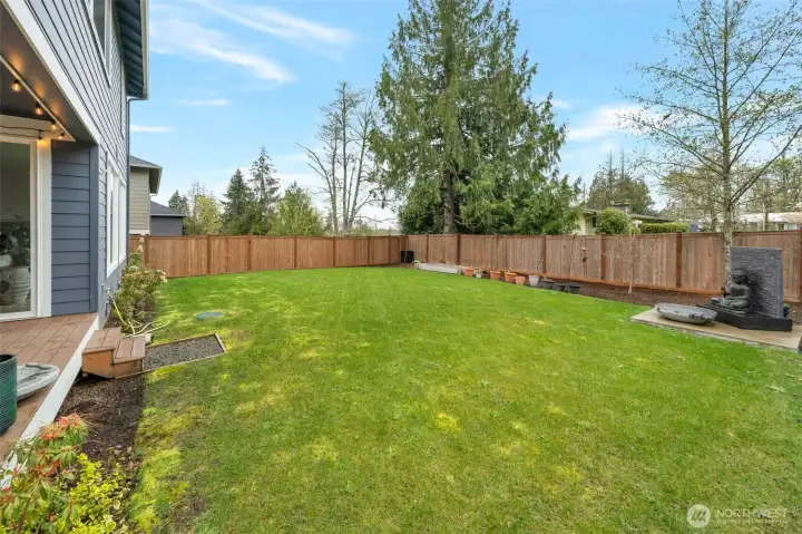Large leveled backyard with space to play and garden