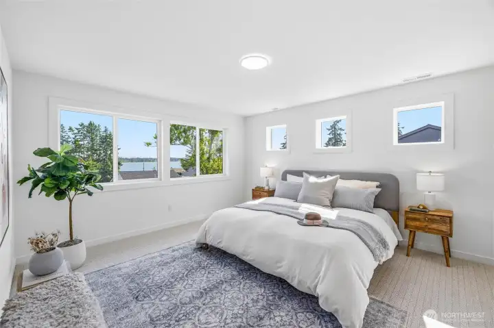 The primary suite is spacious and takes in the bay views. There is a separate dressing area, as well as a stunning full bath and walk-in closet. The primary suite is spacious and takes in the bay views. There is a separate dressing area, as well as a stunning full bath and walk-in closet.