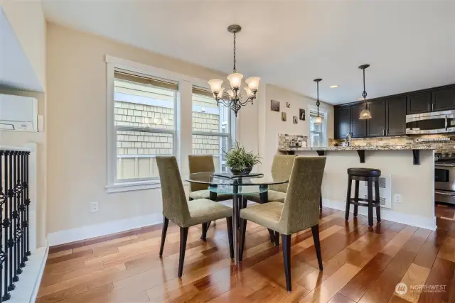 The dining area is a flexible space off the kitchen. Notice the beautiful cherry floors.