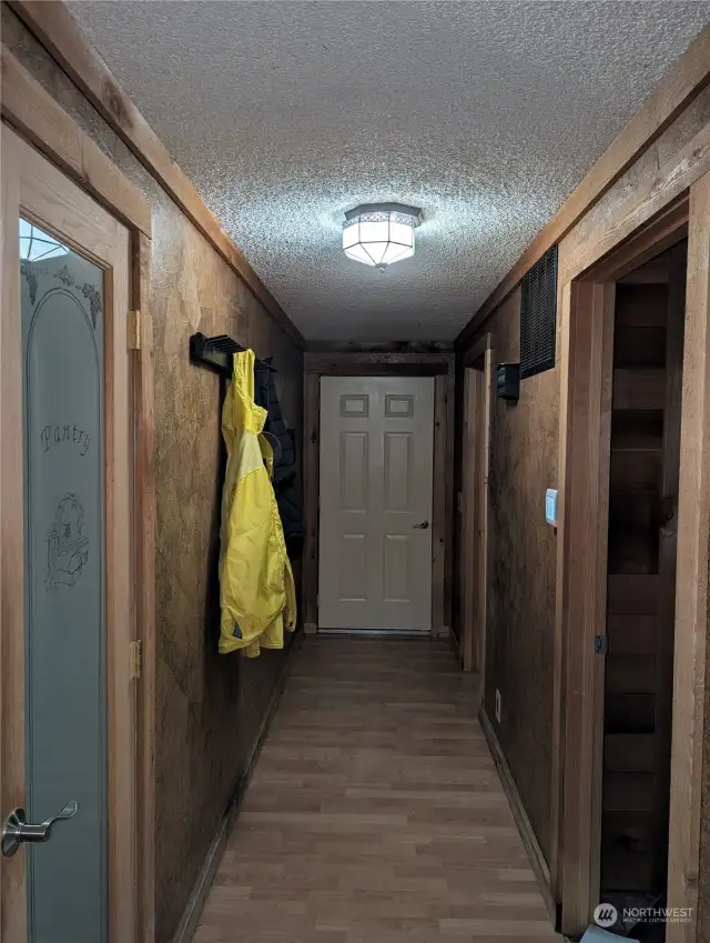 Hall upstairs to pantry, garage and laundry area and upstairs bathroom.