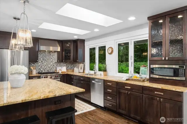 Double sets of windows in the kitchen open out to the backyard. Fun to open them for entertaining or brining the outdoors, in.